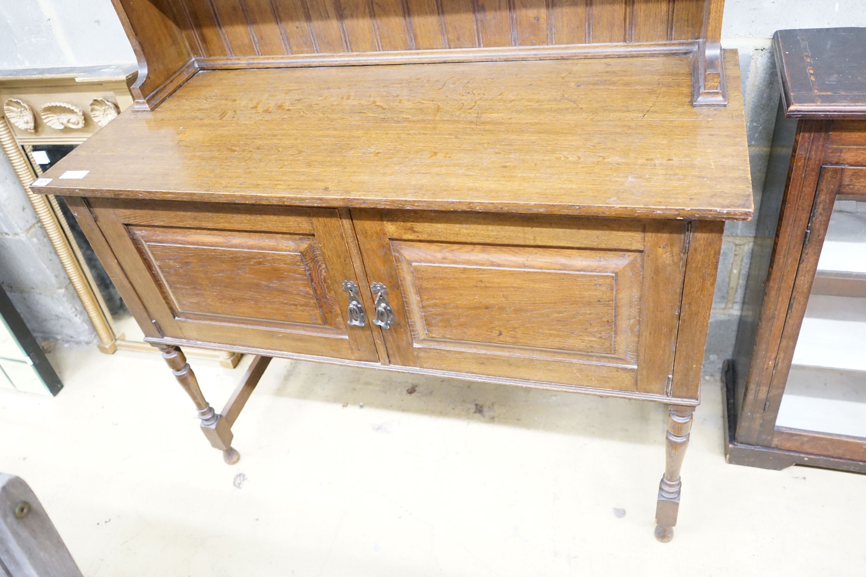 A 1920's oak dresser and plate rack, width 122cm, depth 51cm, height 211cm